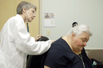 Barbara Lutey, MD, an assistant professor in the Division of Medical Education at Washington University School of Medicine, examines patient Marie Nesbitt at the Center for Outpatient Health. Nesbitt suffers from chronic obstructive pulmonary disease and credits Lutey with saving her life.